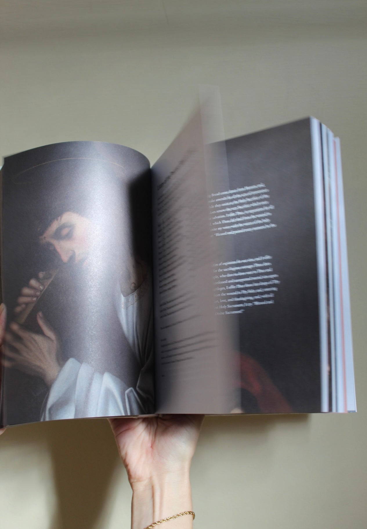 Open Catholic prayer book with traditional prayers and sacred art for daily devotional use