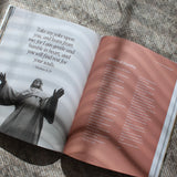 open Catholic prayer book with traditional prayers and reflections from scripture catechism and saints