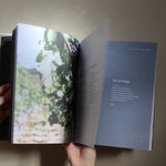 hands opening a Catholic prayer book used for daily prayer and growing in understanding of the faith