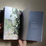 hands opening a Catholic prayer book used for daily prayer and growing in understanding of the faith